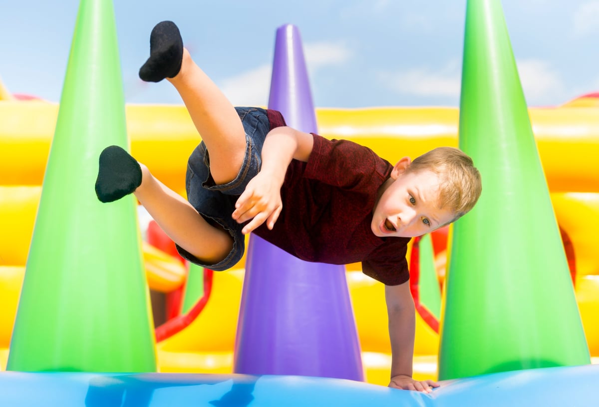 Colorful inflatable moon walk bounce house at outdoor party
