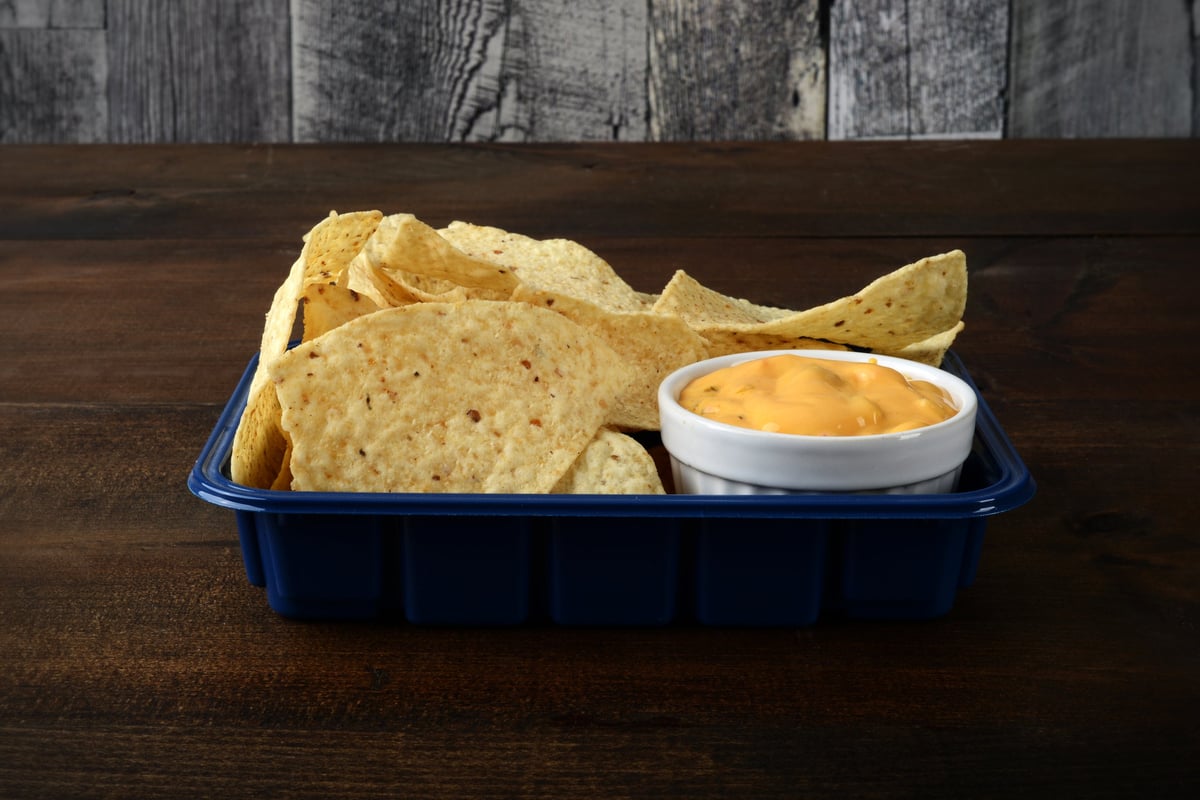Warm nacho cheese dip ready to serve at a concession stand