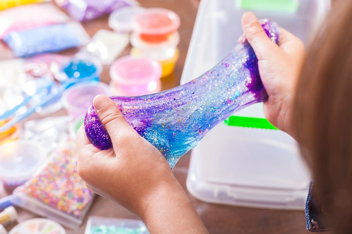 Kids playing with colorful slime kit