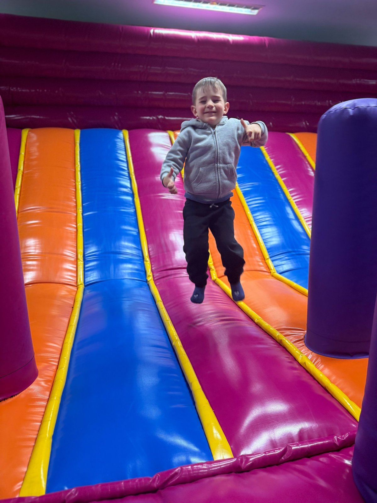 Child joyfully bouncing inside an inflatable bubble bounce house