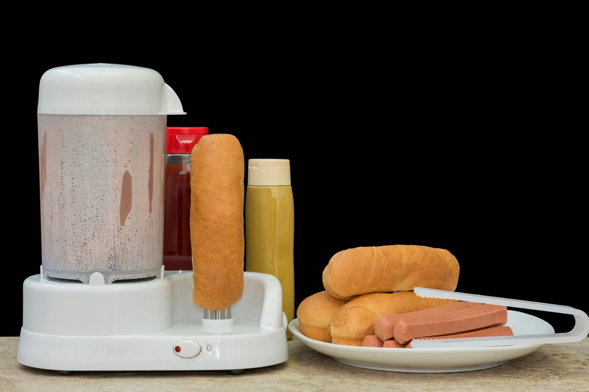 Hot dog roller grill with condiments ready to serve
